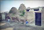 Children playing in front of an old Harran house